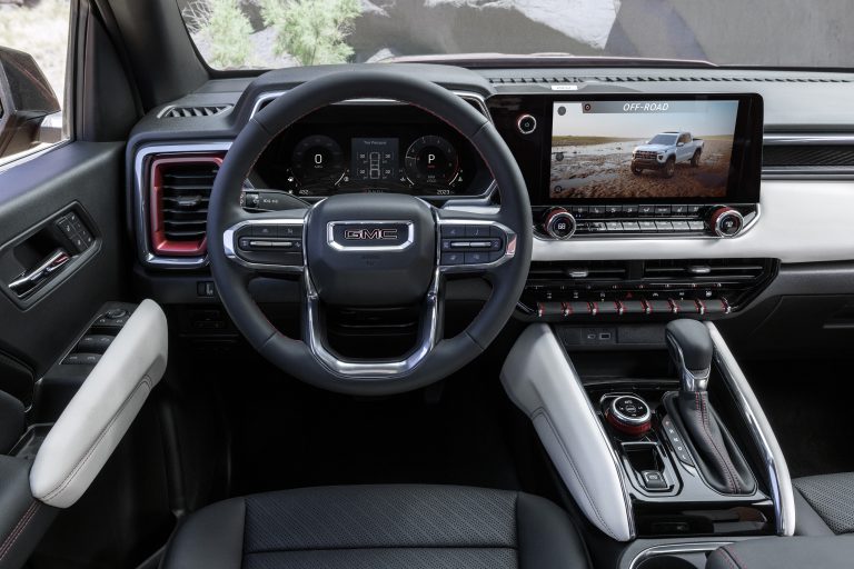 Detailed view of GMC Canyon AT4X with Edition 1 package interior with cluster screen and tight shot of steering wheel.