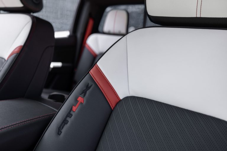 Detail view of GMC Canyon AT4X with Edition 1 package's perforated leather-appointed front seats with AT4X logo in leather.