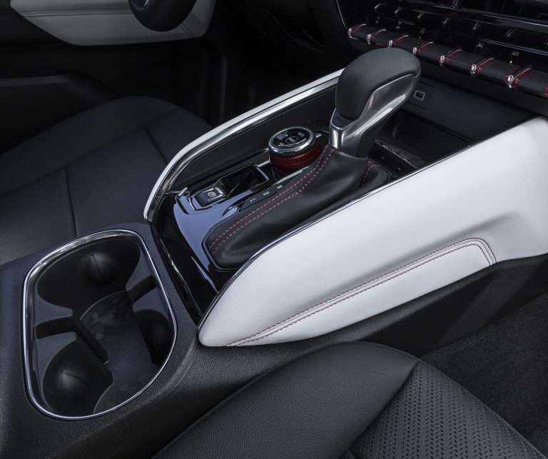 Detail view of GMC Canyon AT4X with Edition 1 package interior center console with gear shifter and cupholders.